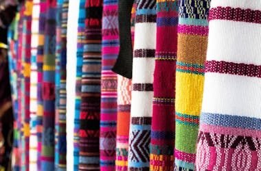 Vibrant woven fabrics showcasing traditional patterns in Antigua Guatemala market.